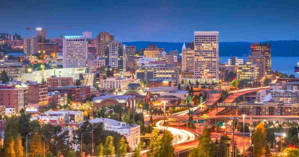 Downtown Spokane skyline at dusk with city lights and highways, highlighting why the area is considered one of the best places to retire in Washington state and served by All Ready Moving.